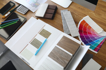 Fototapeta premium Samples of products with color palette lie on table. Design and repair of apartments and houses concept