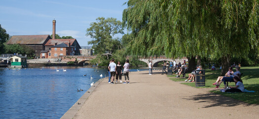 People chatting by The River Avon at Stratford upon Avon in Warwickshire in the UK