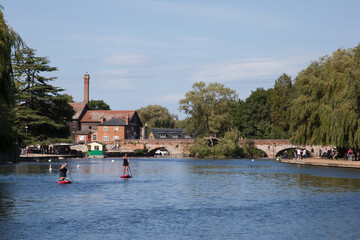 Fototapeta na wymiar People kayaking on The River Avon at Stratford upon Avon in Warwickshire in the UK