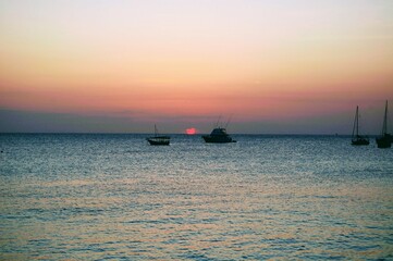 African sunset with boats on the horizon in Zanzibar, Tanzania 