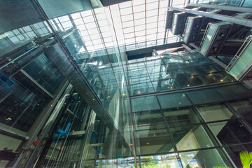Modern glass elevator and pedestrian stairway entrances.