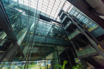 Modern glass elevator and pedestrian stairway entrances.