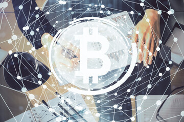 Cryptocurrency hologram over woman's hands writing background. Concept of blockchain. Double exposure