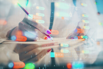 Double exposure of woman's writing hand on background with data technology hud. Big data concept.