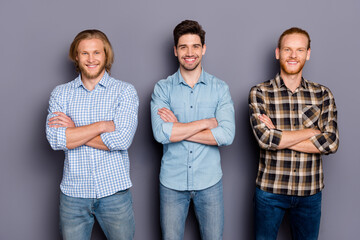 Portrait of three nice attractive cheerful cheery content guys best buddy fellow team it company coworkers folded arms isolated over gray purple pastel color background