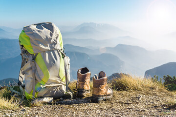Hiking equipment. Backpack and boots on top of mountain Corno di Tres, Tresner Horn, Trentino,...