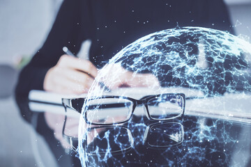 Social network theme hologram over hands taking notes background. Concept of global international people connect. Double exposure