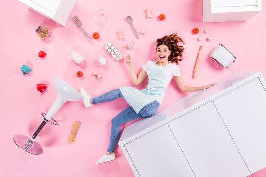 Top above high angle view full length profile side photo astonished positive girl fall down kitchen table impressed have eggs milk utensils roll pin flat lay isolated pastel color background