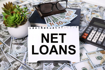 Net loan text concept on white sheet. Still life of an office workplace with supplies. on the...