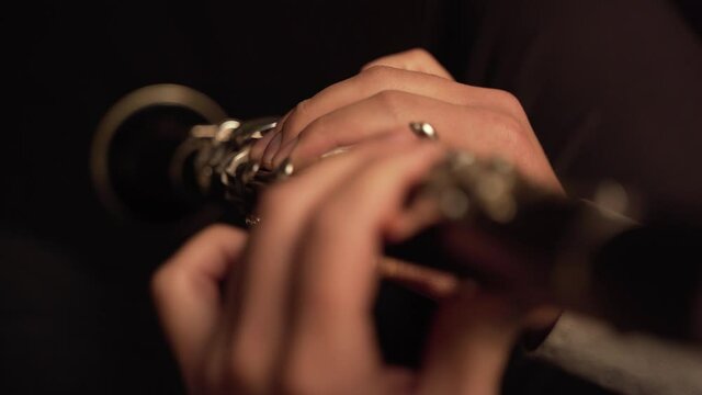 fingers player on Clarinet, in a dark room.  Super Close Up, 
Hasidic Jewish player