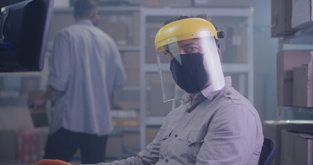 Man wearing protective gear in warehouse