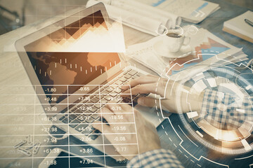 Double exposure of forex graph with man working on computer on background. Concept of market...