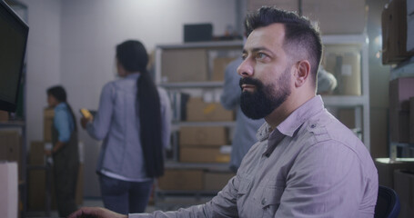 Man scanning packages in warehouse