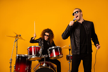 Photo of famous popular rock group redhair lady plays instruments beat drum sticks vocalist guy...
