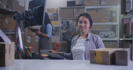 Woman checking packages with barcode scanner