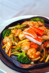 seafood stir-fried with fresh vegetables in a hot pan