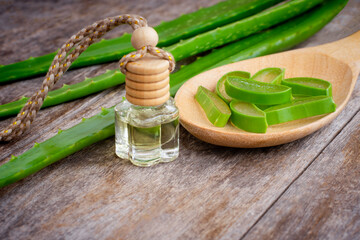 Fresh aloe vera leaf with sliced and glass of aloevera gel isolated on wooden table background. Herbal medicine plant for beauty treatment ,skincare and spa concept.