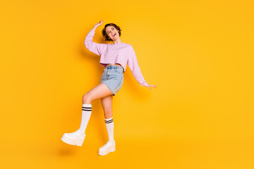 Fototapeta na wymiar Full length body size view of her she nice-looking attractive lovely charming slender cheerful cheery girl dancing having fun fooling isolated on bright vivid shine vibrant yellow color background