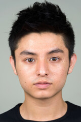 Obraz premium Face of young handsome Asian man looking at camera