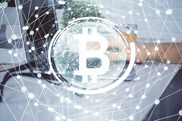 Crypto currency theme hologram with businessman working on computer on background. Concept of blockchain. Multi exposure.