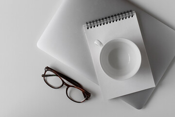 Workplace background with glasses and notebook