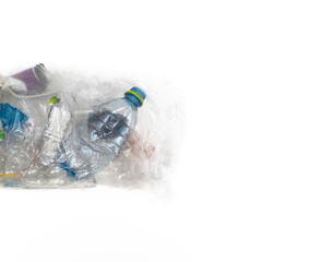Sorting (segregating) household waste at home. Plastic (bottles, packaging) in transparent bag on light background. The environment, separate waste collection, the concept of recycling. Copy space