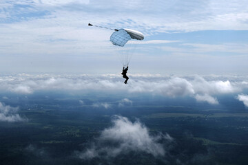 Naklejka na ściany i meble Skydiving. A parachute is in the sky.