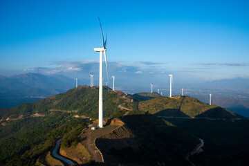 Wind turbines are up in the mountains.