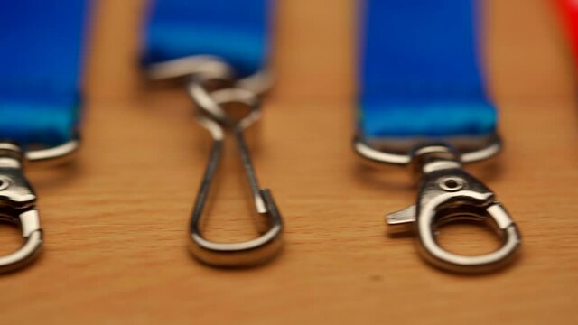 Macro detail shot of souvenirs neck ribbons lanyards clips panning