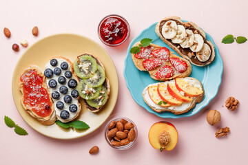 Sweet sandwiches with fruits and berries on pink colorful background.