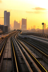 Fototapeta na wymiar curved metro track at beautiful sunset in Dubai , city of future