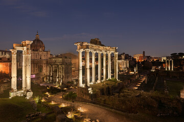 Fototapeta na wymiar Ruins of the Roman Forum at night in Rome, Italy
