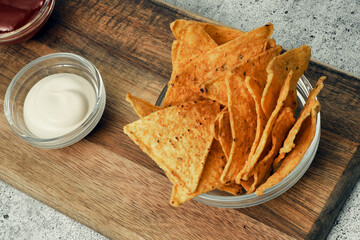 Corn cheese, snacks with sauce on a wooden stand. Beer snack, dish on the menu. Close up.