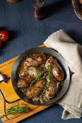 Homemade white sausage fried with onion and herbs