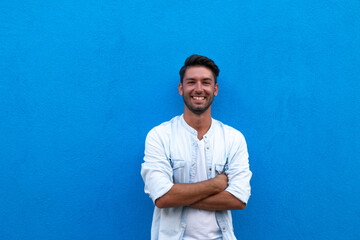 smiling man posing outdoors on a blue background