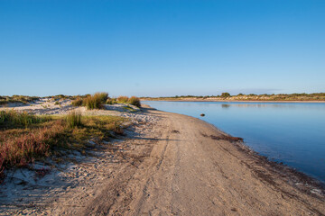 Fototapeta na wymiar sandy path with river next to it