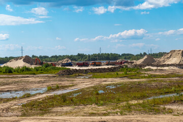 Fototapeta na wymiar Construction site preparation. Sand dumping by truck.