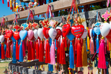 The multitude of colorful hearts with tassels for wishes and names of visitors on the stand of Yun Lai viewpoint in Santichon Village, Pai, Mae Hong Son Province, Thailand.