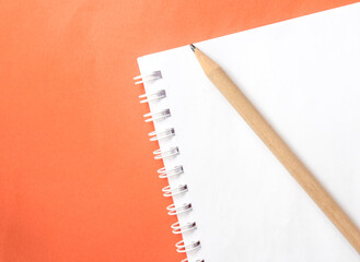 notebook and pencil on a color background