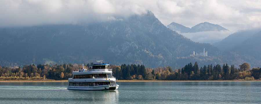Fussen, Germany, October 21, 2019:  river boat on the lake Forggensee in autumn near Alps mountains