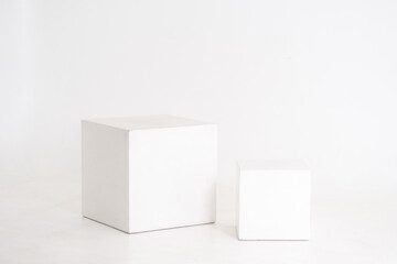 two white wooden cubes on a white background