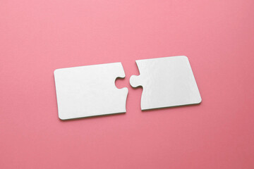 two empty puzzles for text on a pink background 