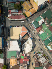 Aerial, looking down at typical urban area in Metro Manila, in Guadalupe, Makati. Roofs of Mid rise buildings and houses. Chaotic street layout.