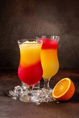Delicious cold refreshing colorfull smoothie drinks in cocktail glases with fruits