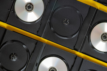 Creative background with dvd and blue ray discs on yellow.