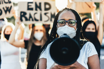 People from different ages and races protest on the street for equal rights - Demonstrators wearing face masks during black lives matter fight campaign - Focus on woman face - obrazy, fototapety, plakaty