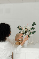 Artificial flowers in a girl's hands. Decorative flowers as a gift. Artificial flowers in the interior. Decorative flowers and hands of a girl.