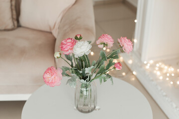 Artificial flowers in a vase. Decorative flowers in the interior. Flowers as a gift. Flowers in gift wrapping.