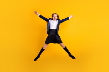 Fototapeta na wymiar Full length body size view of her she nice small little cheerful excited crazy overjoyed girl jumping having fun vacation fooling isolated bright vivid shine vibrant yellow color background