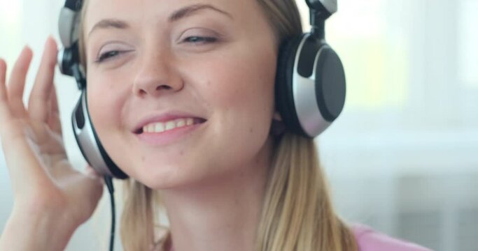 Happy woman listening music on headphones 